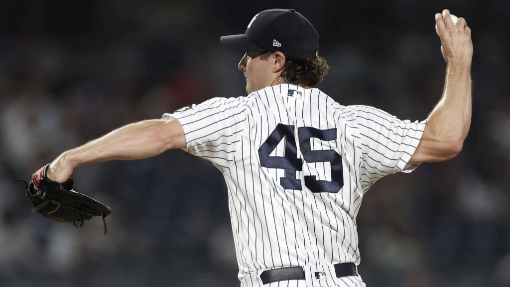 Gerrit Cole pitching for New York Yankees number 45 in action with blurred stadium background Wallpaper