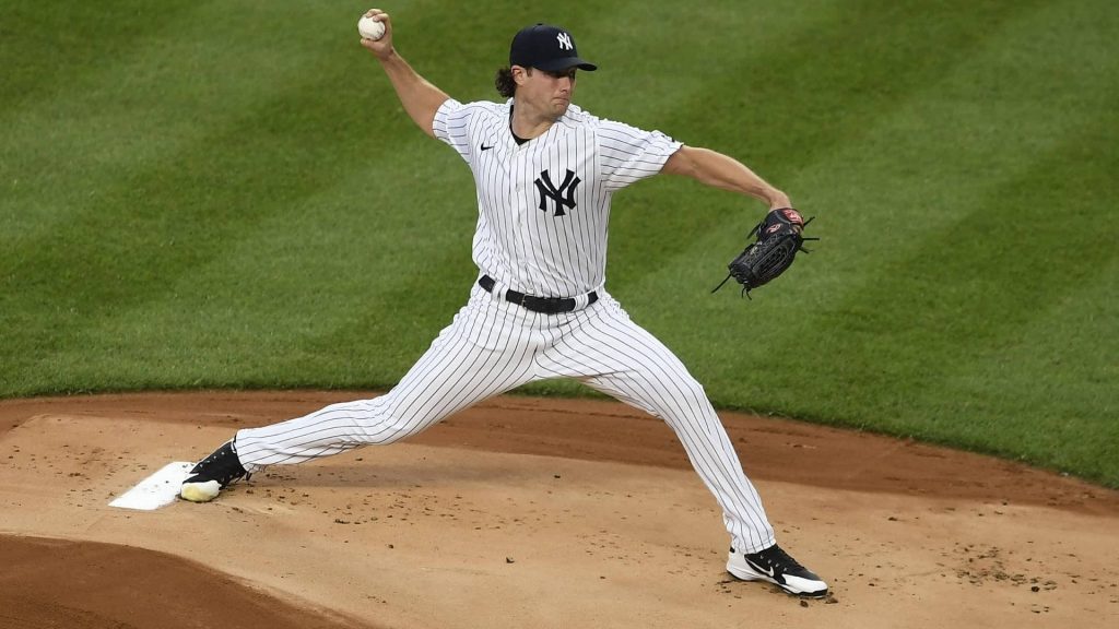 New York Yankees pitcher Gerrit Cole mid-pitch in iconic pinstripe uniform on vibrant field Wallpaper