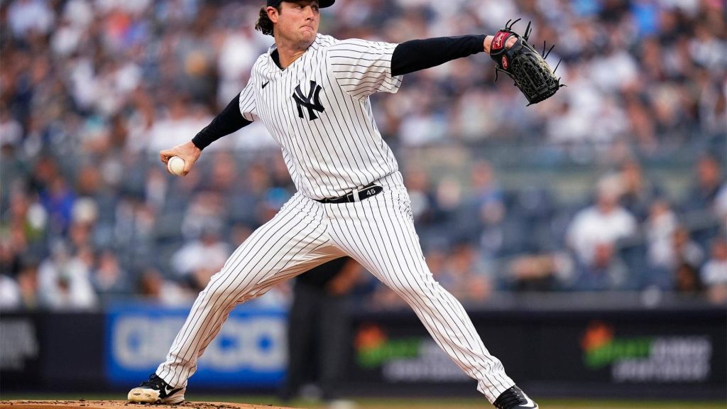 Gerrit Cole pitching for Yankees in pinstripe uniform intense delivery on baseball mound wallpaper