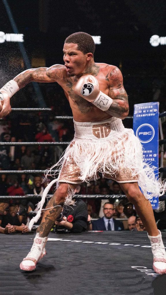 Gervonta Davis mid-punch in white rose gold trunks high-energy boxing action wallpaper background