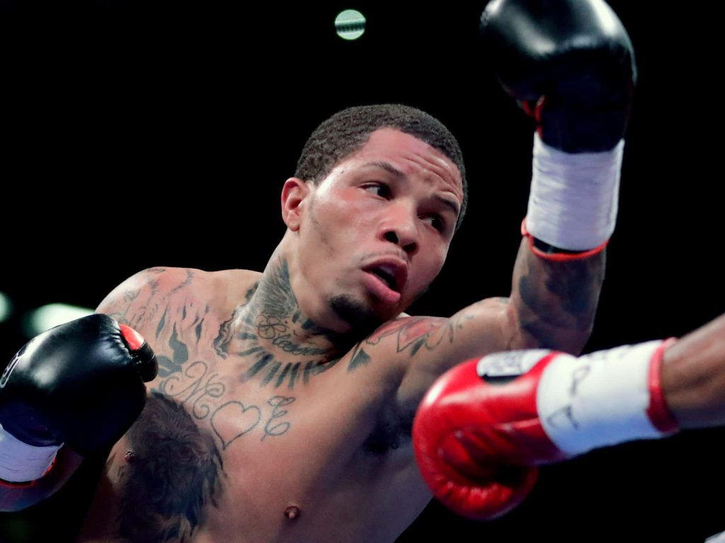 Gervonta Davis punching in boxing ring intense action shot detailed tattoos wallpaper background