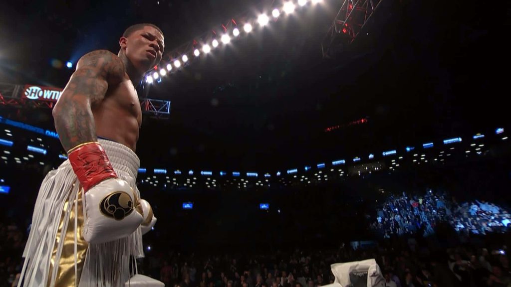 Gervonta Davis intense boxing pose low angle dark stadium bright arena lights wallpaper background