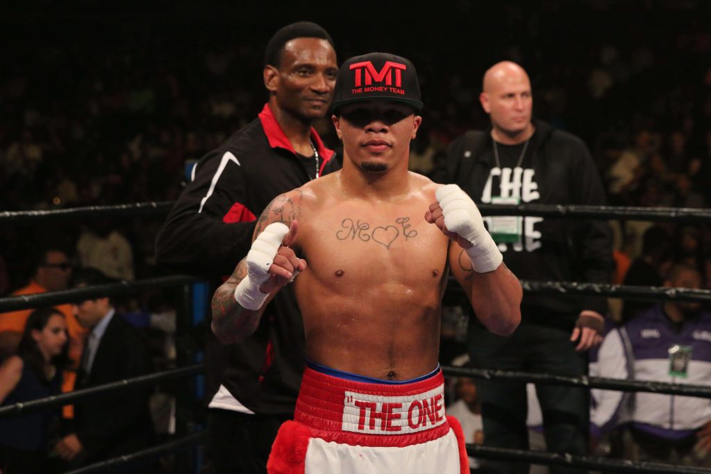 Gervonta Davis intense boxing ring wallpaper wearing TMT cap THE ONE trunks chest tattoos white wraps