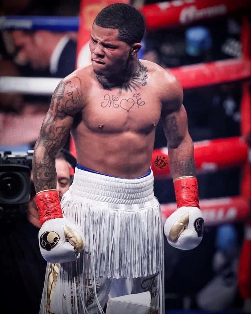 Gervonta Davis in white trunks boxing gloves intense fight night action wallpaper background