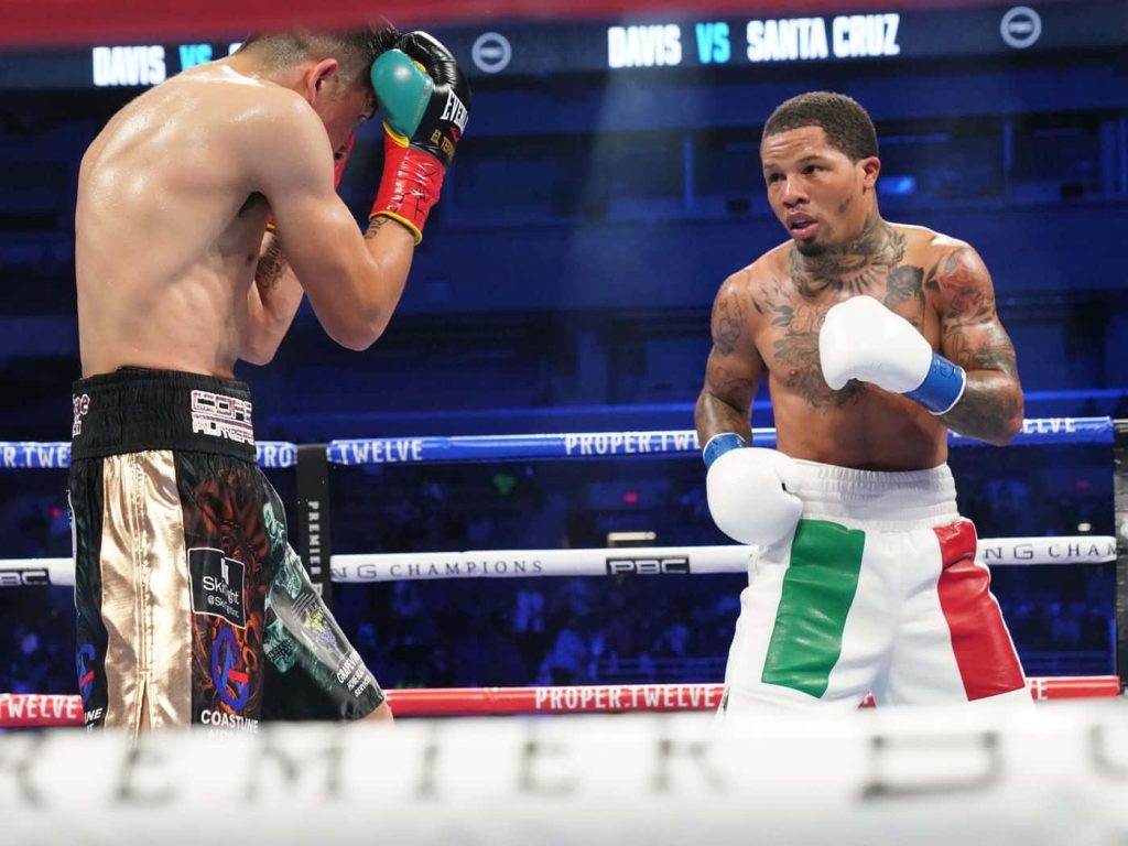Gervonta Davis in white shorts landing punch on Leo Santa Cruz in intense boxing match wallpaper