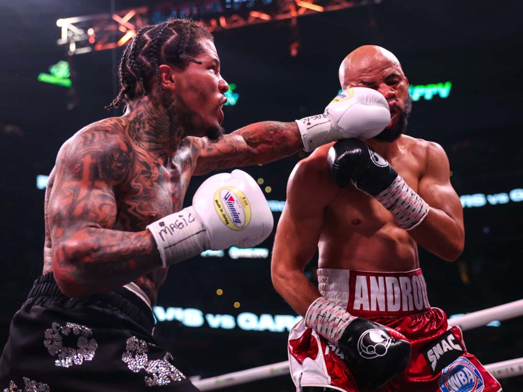 Gervonta Tank Davis lands powerful punch on Hector Luis Garcia in intense boxing match ring Wallpaper