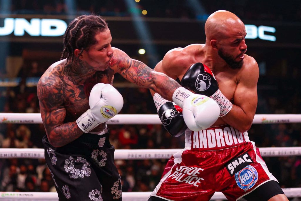 Boxing champion Gervonta Davis punches Hector Garcia intense action stadium lighting wallpaper
