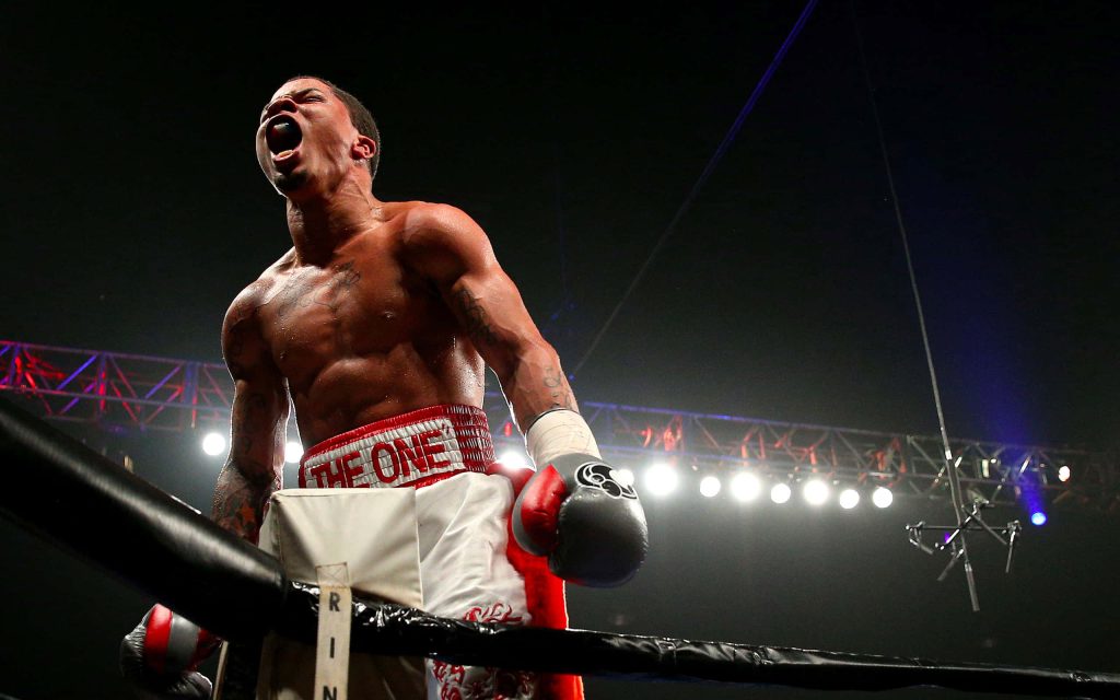 Gervonta Tank Davis roaring in victory inside boxing ring wearing THE ONE trunks wallpaper