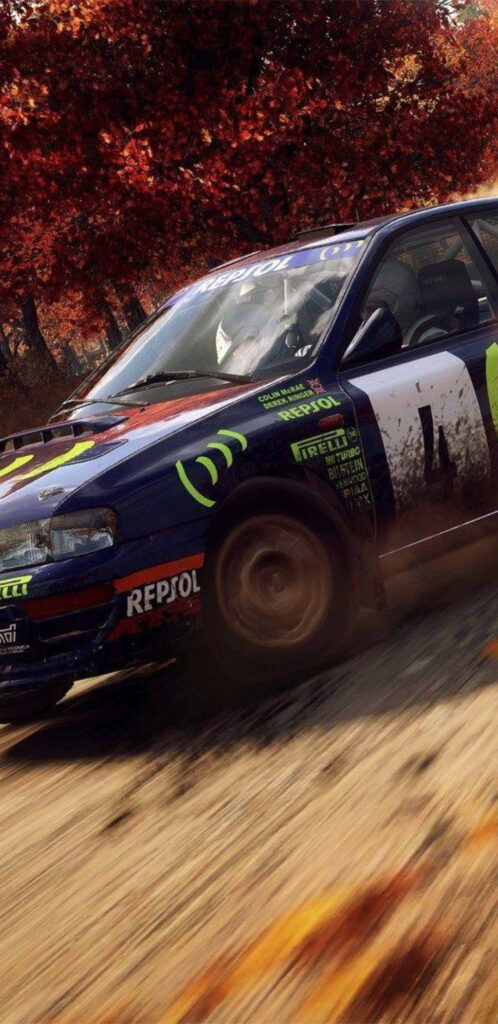 Rally car speeding through autumnal forest track with sponsor logos Wallpaper