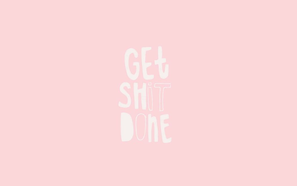 Minimalist Get Shit Done wallpaper with white hand-lettered text on pastel pink background