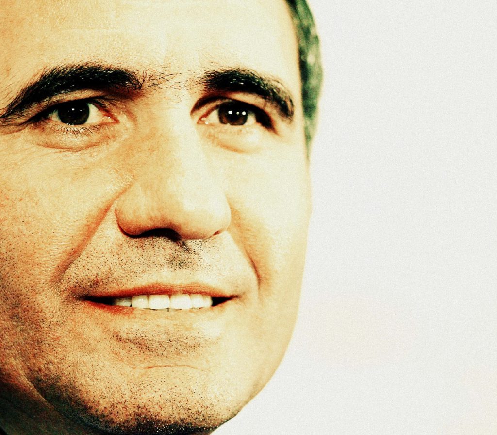 Close-up portrait of Gheorghe Hagi Romanian football legend with warm studio lighting wallpaper