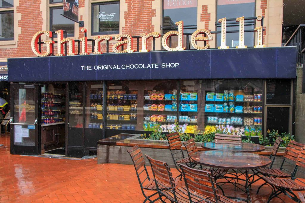 Ghirardelli Square San Francisco chocolate shop glowing sign rainy brick patio wallpaper background