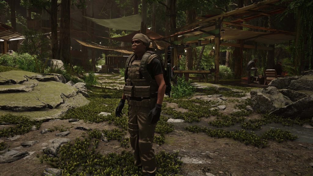 Tom Clancy’s Ghost Recon Breakpoint operative in military gear in dense forest encampment background Wallpaper