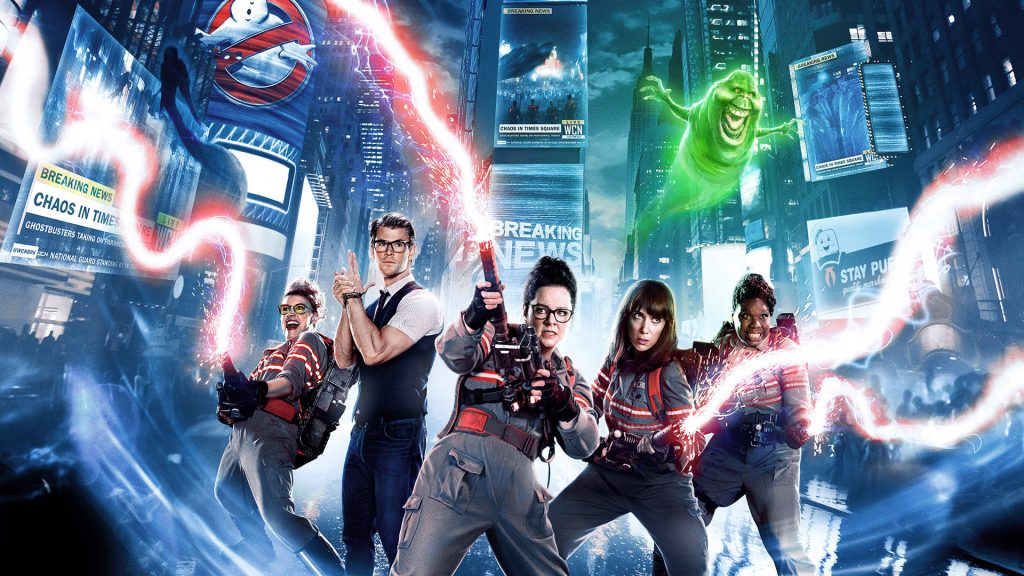 Ghostbusters 2016 team with glowing proton packs in neon Times Square with Slimer background Wallpaper