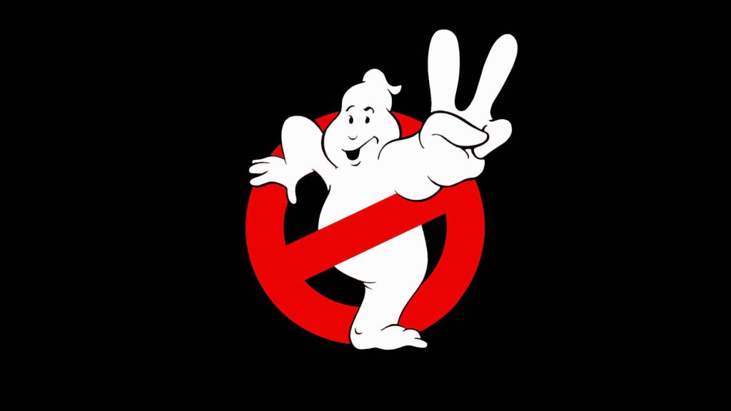 Ghostbusters wallpaper with No-Ghost Mooglie mascot flashing peace sign on black background