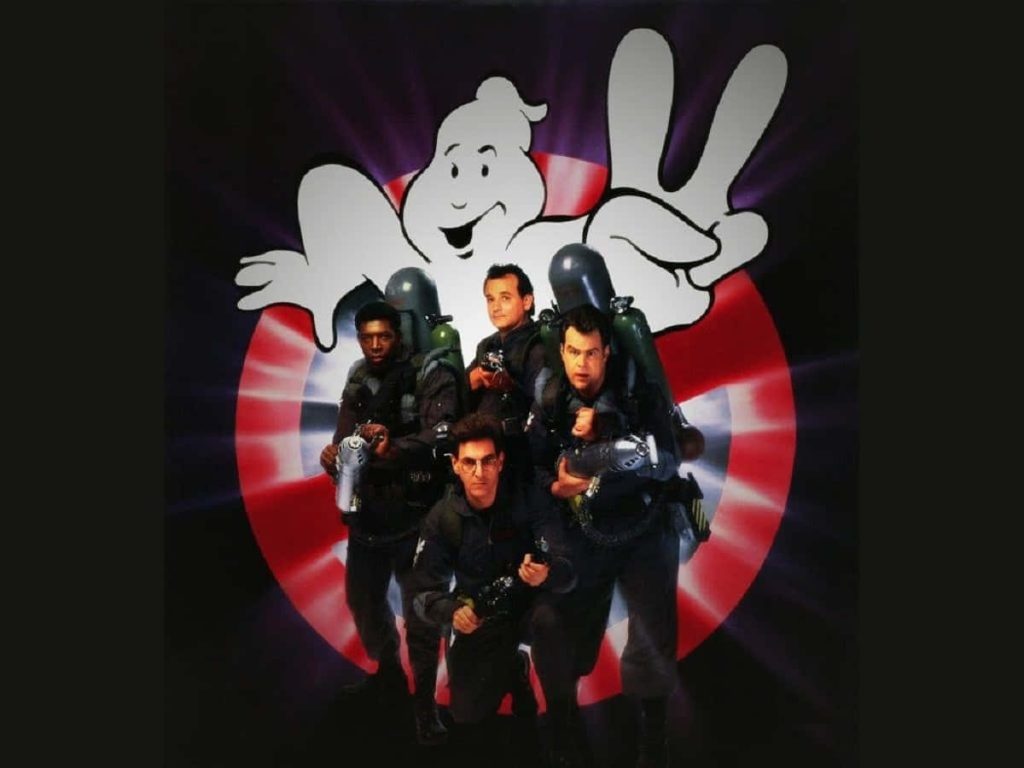 Original Ghostbusters team with proton packs against red and white No-Ghost logo wallpaper