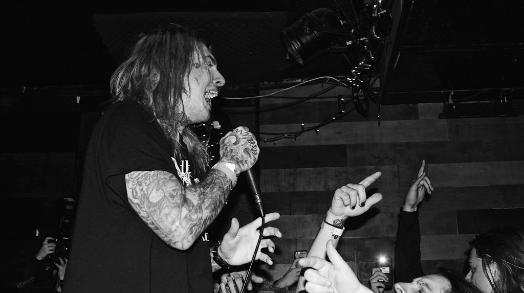 Ghostemane side profile singing into mic black and white concert wallpaper with crowd hands