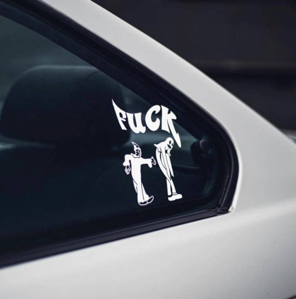 White FuCK vinyl car decal with cartoon figures on tinted window hip hop streetwear style Wallpaper