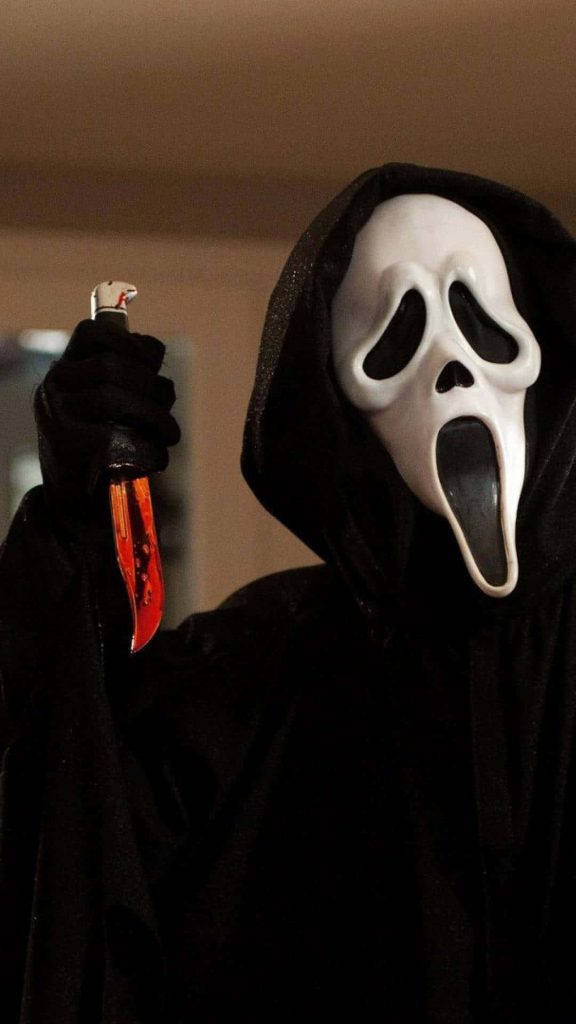 Close-up of Ghostface horror villain in black hood with red-stained dagger wallpaper background