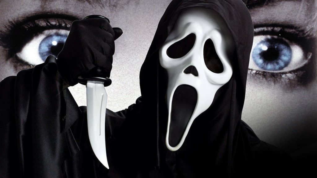 Ghostface from Scream in dark hooded robe with knife and piercing blue eyes wallpaper background