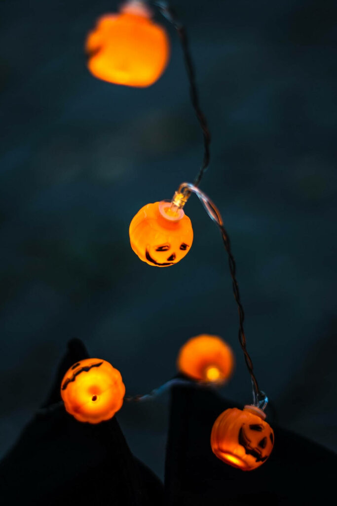 Enchanting Halloween Atmosphere: The Allure of Grunge Pumpkin Lights Wallpaper