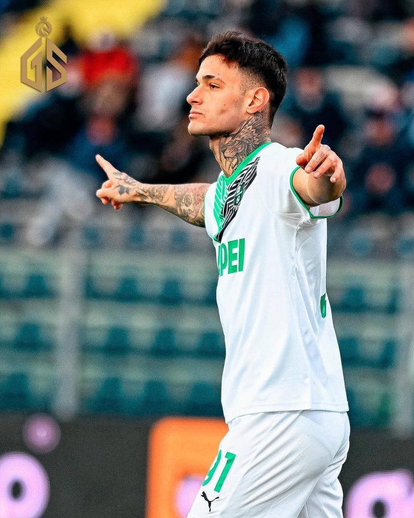 Gianluca Scamacca celebrating goal in Sassuolo kit with vibrant stadium background wallpaper
