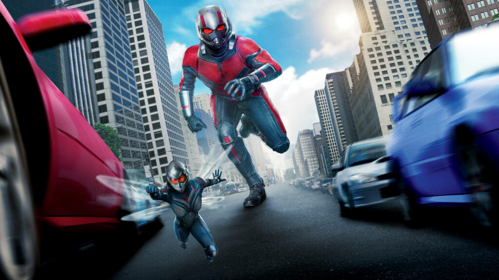 Bigger Ant Man running through city street with smaller Ant Man showcasing size-changing powers Wallpaper