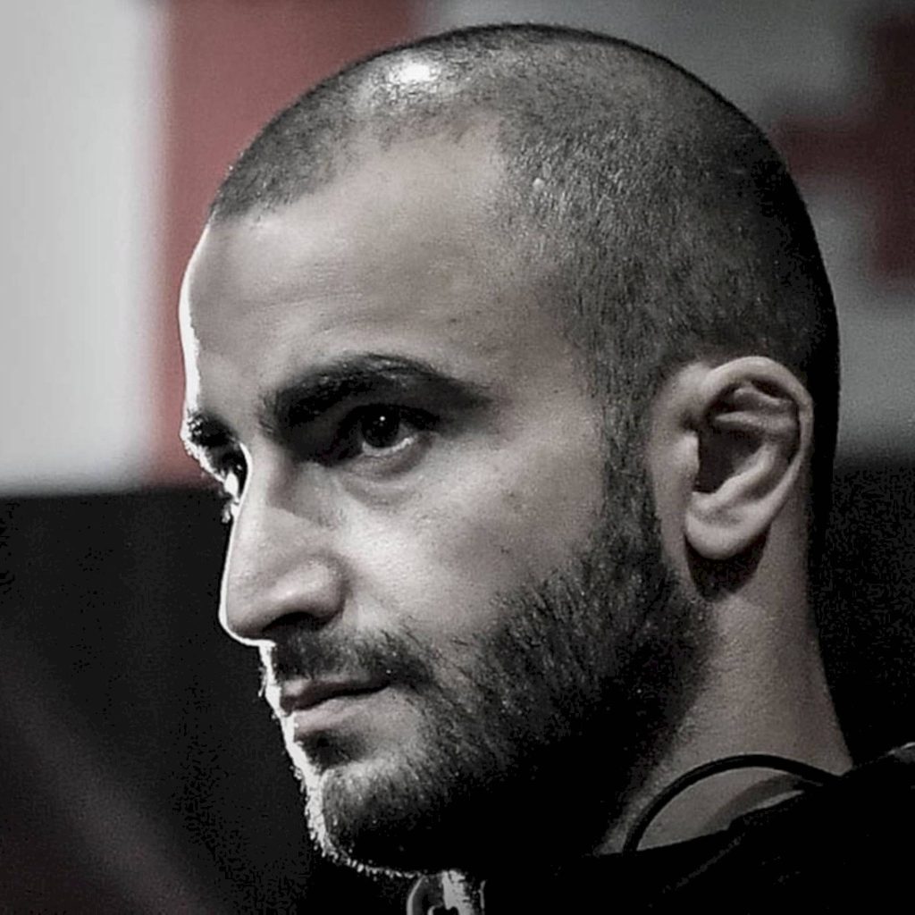 Close-up black and white portrait of MMA fighter Giga Chikadze with intense focused expression Wallpaper