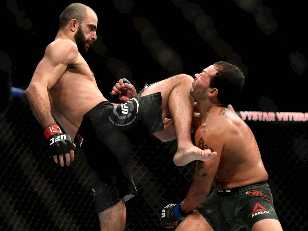 UFC fighters Giga Chikadze and Cub Swanson Octagon intense knee strike MMA wallpaper background