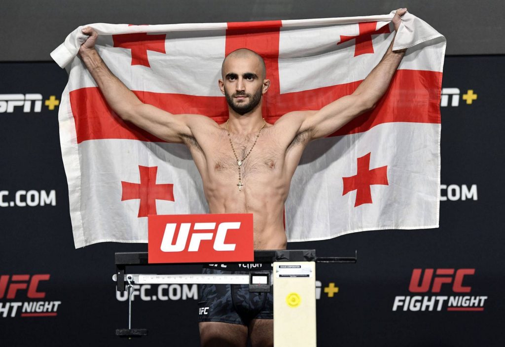 Giga Chikadze UFC weigh-in portrait with Georgian flag and crucifix necklace background wallpaper
