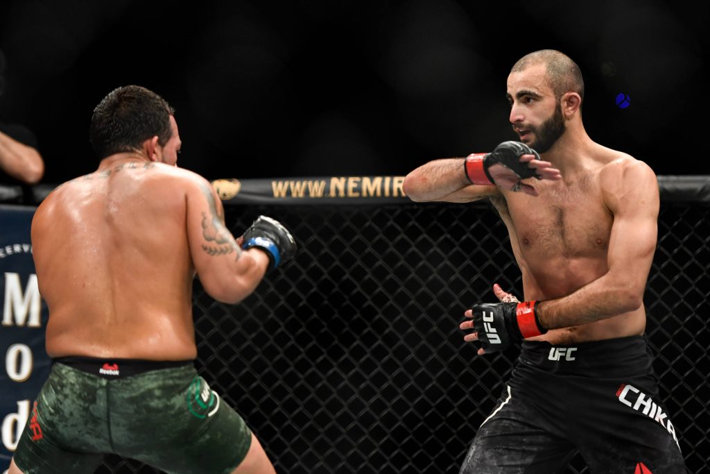 Giga Chikadze UFC action wallpaper arm defense intense MMA fight arena lighting background