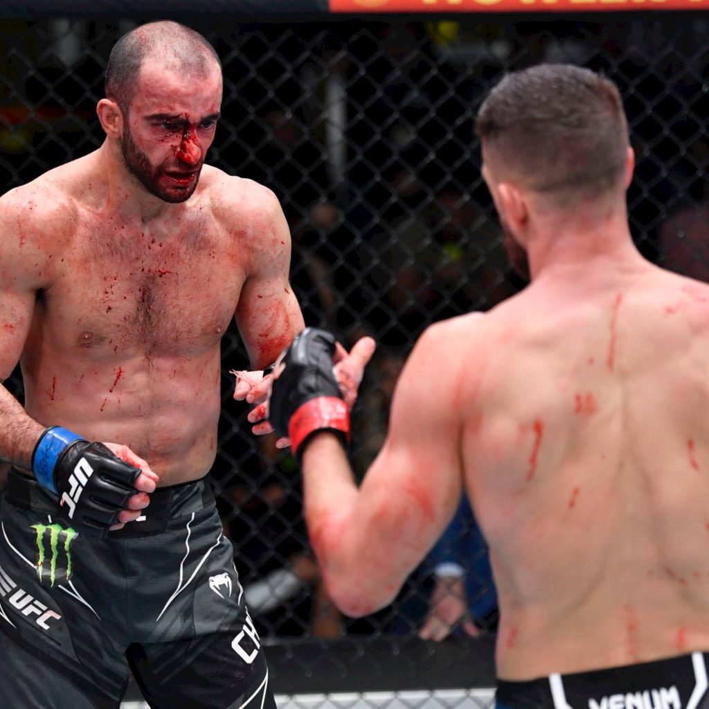 Giga Chikadze vs Calvin Kattar intense UFC Octagon fight with bloodied MMA action wallpaper