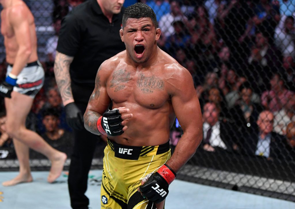 Gilbert Burns pumped up in UFC octagon shouting intense MMA fight moment wallpaper background