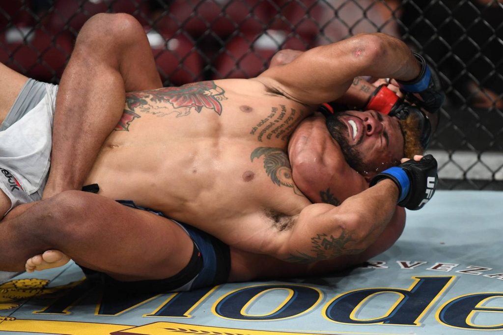 Gilbert Burns and Kamaru Usman intense MMA UFC grapple action in Octagon ground battle wallpaper