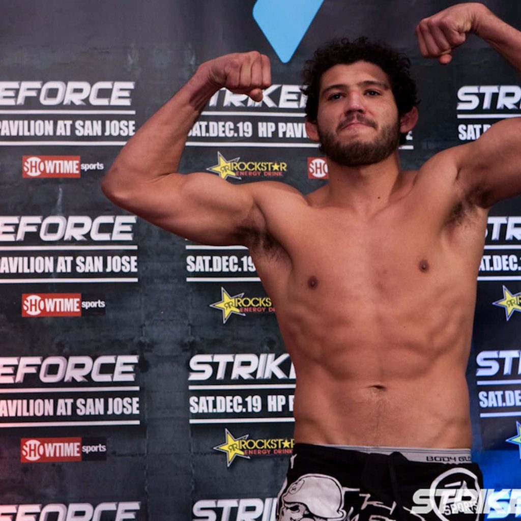 MMA fighter Gilbert Melendez flexing muscles and abs at Strikeforce HP Pavilion event wallpaper