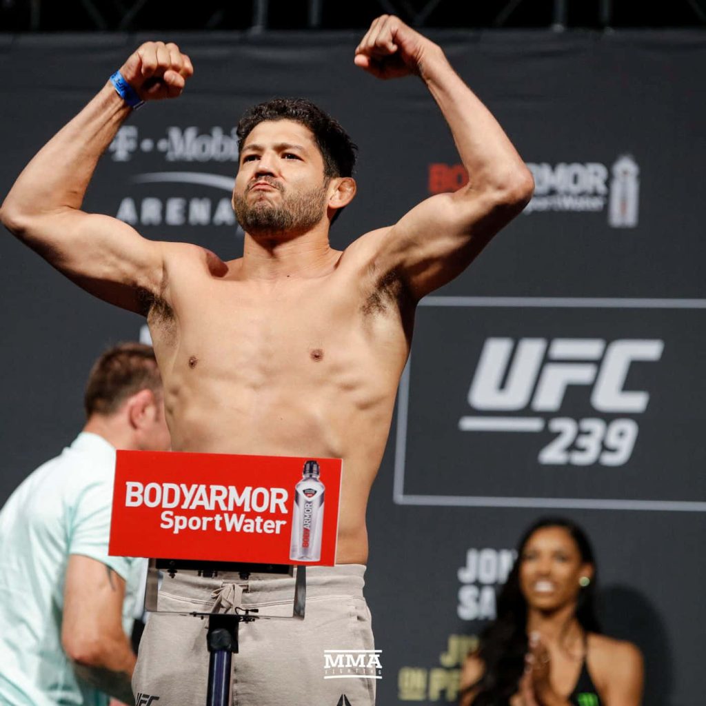 Gilbert Melendez flexing muscles at UFC 239 weigh-in showcasing MMA fighter intensity Wallpaper