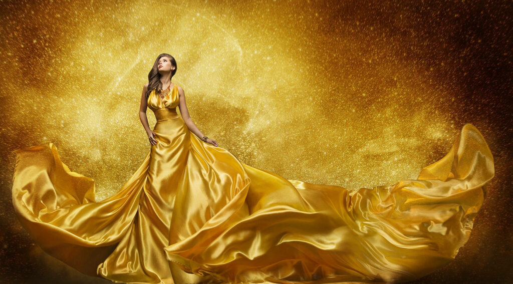 Glamorous Golden Gown Illuminated by Mesmerizing Dusty Gold Background Wallpaper