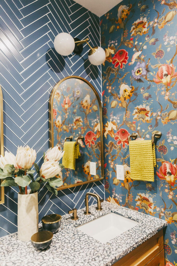 Gilded Reflections: A Radiant Wallpaper Elevating the Powder Room with a Floral-Inspired Golden Frame Mirror