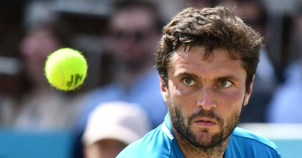 Gilles Simon focused on yellow tennis ball in sharp vibrant blue tennis action wallpaper background