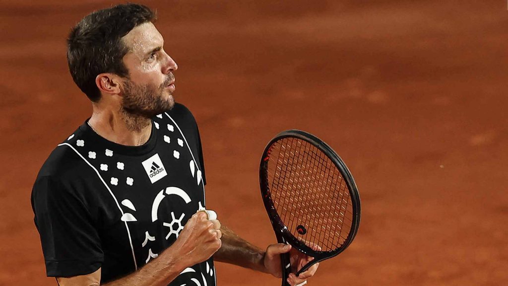 Gilles Simon intense tennis match red clay court black Adidas tee racket action wallpaper