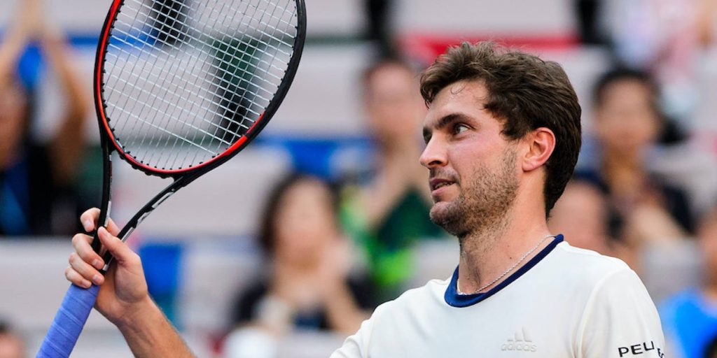 Gilles Simon celebrating tennis win holding racket in stadium with blurred crowd background wallpaper