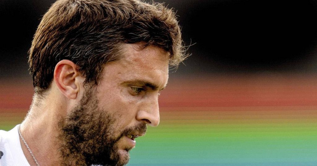Close-up of French tennis player Gilles Simon with intense expression in sunlit stadium background Wallpaper