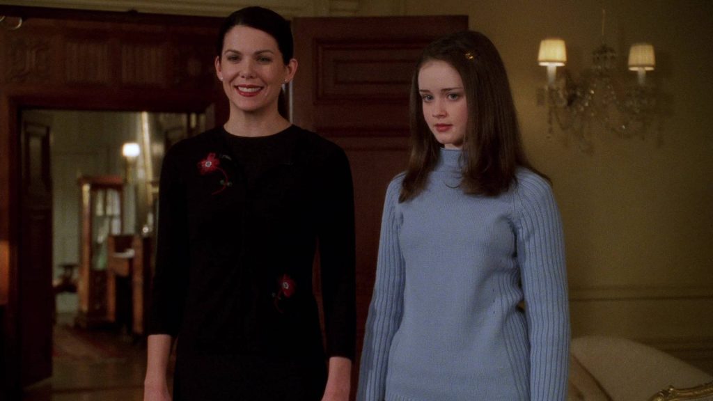 Gilmore Girls wallpaper Lorelai in black floral sweater Rory in blue turtleneck Stars Hollow home