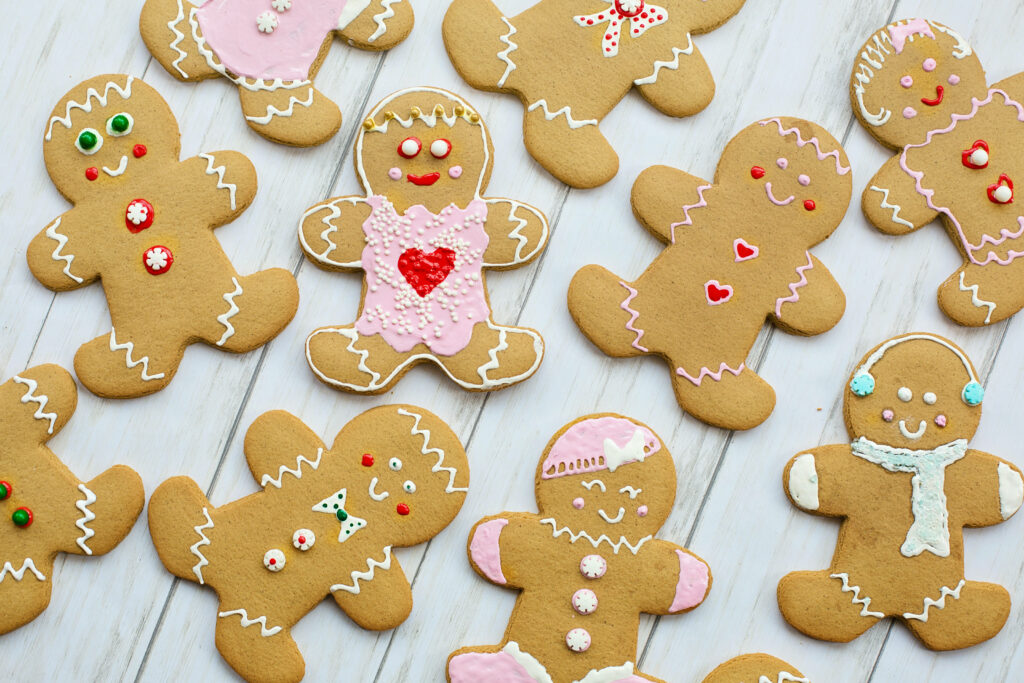 Festive Array of Adorable Gingerbread Characters, Whimsically Decorated for Christmas Delight! Wallpaper