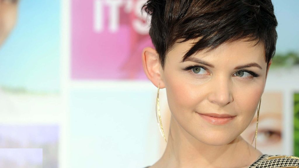 Ginnifer Goodwin close-up portrait with short dark pixie hair soft green eyes gold earrings wallpaper background
