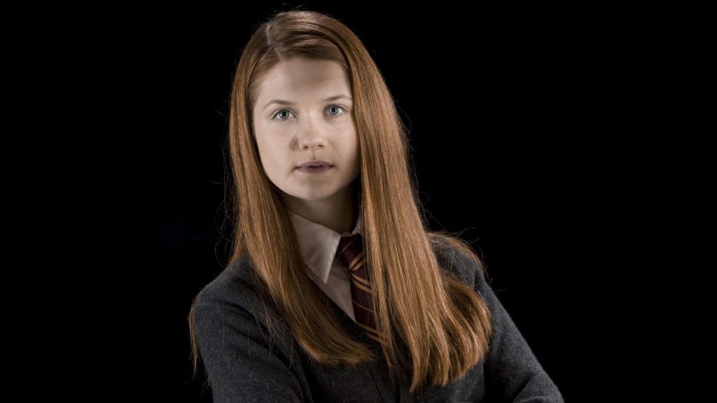 Ginny Weasley portrait in Gryffindor uniform on black background Harry Potter wallpaper