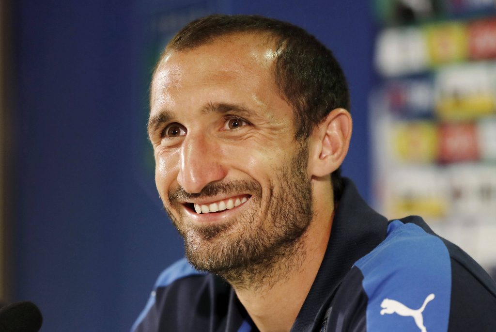 Giorgio Chiellini smiling in blue Puma jacket close-up at Italian football press conference wallpaper