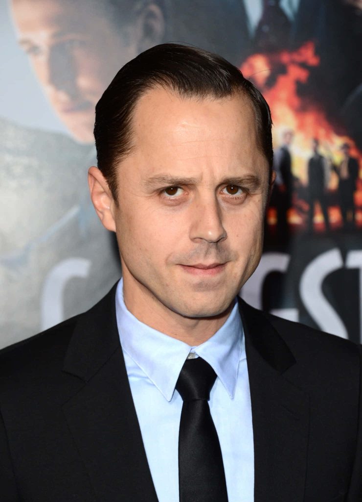 Actor Giovanni Ribisi in formal black suit posing at red carpet event with sharp gaze wallpaper background