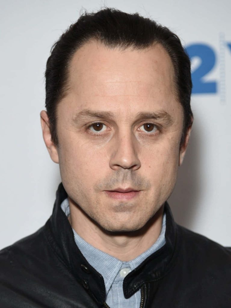 Giovanni Ribisi intense portrait headshot black leather jacket light blue shirt neutral background Wallpaper