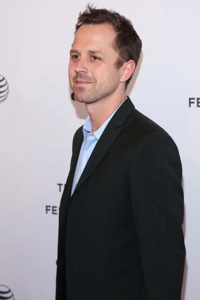 Giovanni Ribisi in black blazer and blue shirt against bright backdrop professional portrait Wallpaper